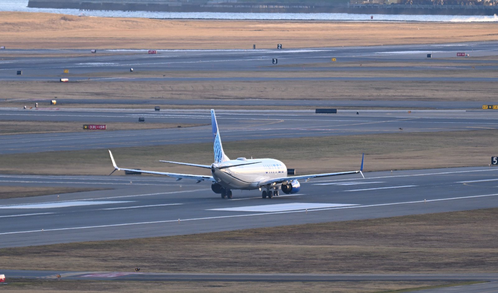 A Boeing 737 on its takeoff roll, wheels still on the runway, accelerating toward V1